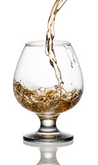 Brandy or whiskey is poured into a glass