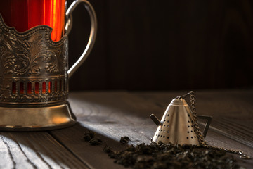 The strainer on the background of the mugs with tea