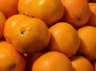 Obraz na płótnie Canvas Pile of Large Fresh Navel Oranges for Background,Close Up Stack of Large Fresh Navel Oranges Texture,Group of Large Fresh Navel Oranges.