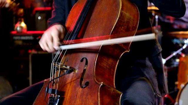Man plays the cello on stage
