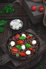 Dark brown buckwheat pasta with mozzarella