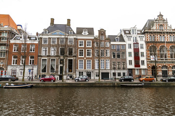 Fototapeta na wymiar Amsterdam, March 17, 2017: Canals and house view from Amsterdam, where city of bikes, canals and peace