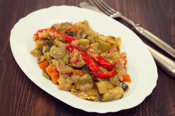 vegetable stew on white dish on wooden background