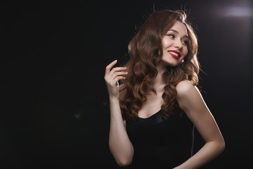 Cheerful gorgeous woman with red lips posing and looking away