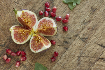 Fresh figs and pomegranate cut into four pieces. Overhead, top view.