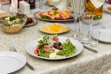 Caesar salad with fried meat, bacon, egg, croutons and lettuce leaves.