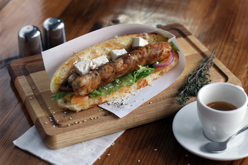 Hot Dog on wooden background board with coffee,  salt.