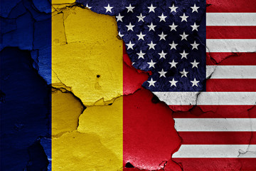 flags of Romania and USA painted on cracked wall