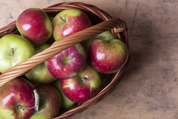 tasty organic apples in a wicker basket