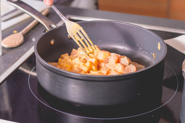 Cook frying chicken in a pan of oil