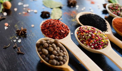 Various spices on wooden spoons. Food ingredients