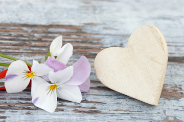 heart and flower lying on wood