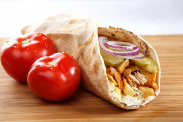 An appetizing chicken wrap with cucumbers and tomatoes