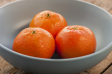 Fresh mandarins on a wooden board.