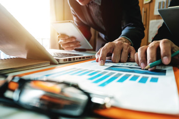 Fototapeta premium Business team meeting present.professional investor working with new startup project. Finance managers task.Digital tablet laptop computer design smart phone in morning light 