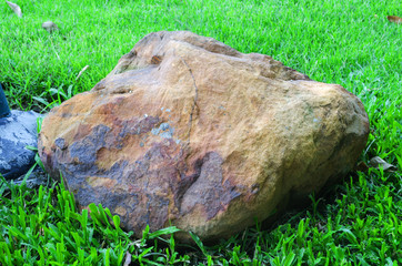 Big granite rock stone,Rocks on green grass.