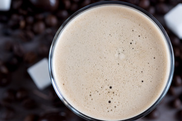 Bottle of black coffee and bottle of coffee with milk lying on background Horizontal photo