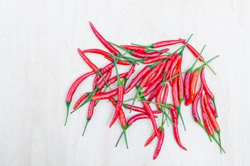Fresh red hot chilli peppers with spicy on the wooden table with copy space