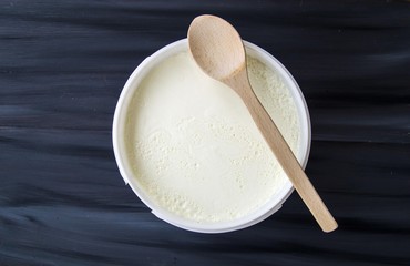 Yogurt in the bucket, yogurt fermented, yoghurt with spoon to take

