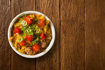 Farofa and red peppers. Traditional Brazilian side dishes.