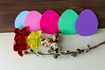 A set of elements for decorating a house for the Easter holiday. Egg, paper flowers, willow branches. Top view. Selective focus.