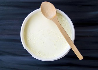Fototapeta na wymiar Yogurt in the bucket, yogurt fermented, yoghurt with spoon to take