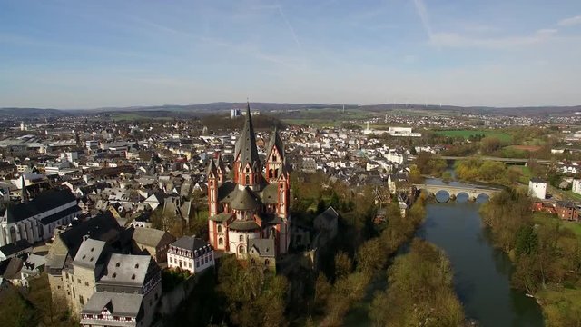 The cathedral of Limburg. On a sunny day an aerial shot of Limburg with its older inner city and the new buildings in the back. The river Lahn can be seen in the foreground.