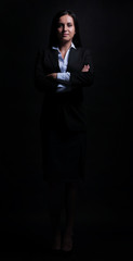 Obraz na płótnie Canvas Full-length portrait of businesswoman isolated on black backgro
