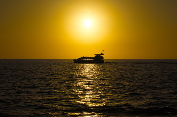 Silhouette of a ship at sunset.