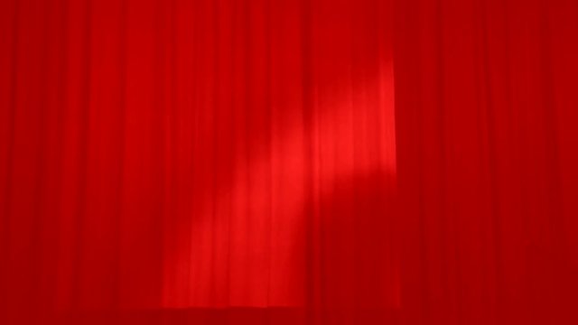 Background of the Theatrical red curtains of the stage. Stage drape covering the stage for the actors.