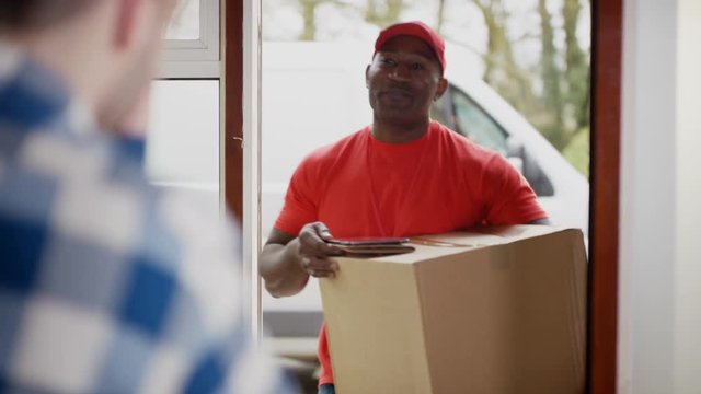  Delivery driver bringing package to customer's door & getting signature