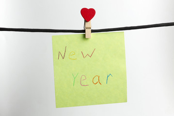 Paper weighs on the black rope with the words happy new year.