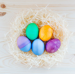 colored Easter eggs in nest