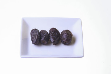Dried dates isolated on white background.