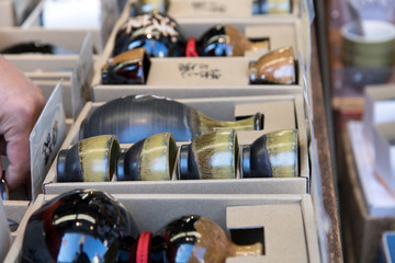 Japanese ceramics offers at store. Ceramic beverage service in paper boxes. Gift souvenirs Shop, Tokyo, Japan.