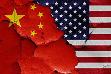 flags of China and USA painted on cracked wall