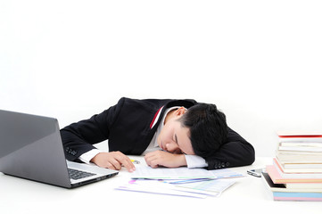 young asia businessman is sleeping at desk office on white background