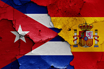 flags of Cuba and Spain painted on cracked wall