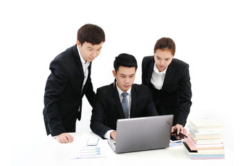 a group of business people working together with a laptop at office