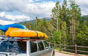 Boats on top of a car.