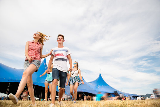 Teenagers At Summer Music Festival In Front Of Big Blue Tent