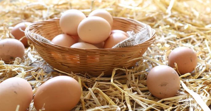 Basket of organic hen eggs in a rural farmers market - dolly shot 4K.