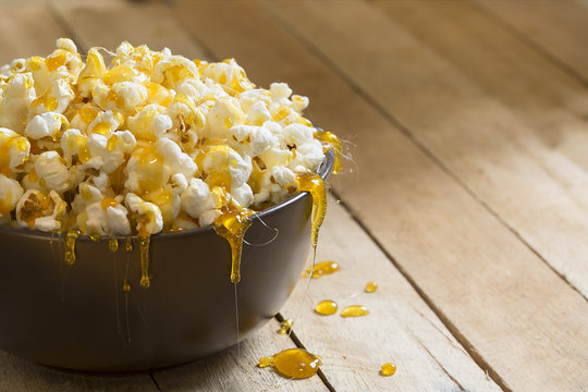 Popcorn in a bowl with dripping caramel on top