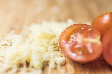 Cherry tomatoes and cheese on a cutting board