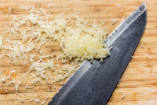 knife and cheese on a cutting board - Powered by Adobe