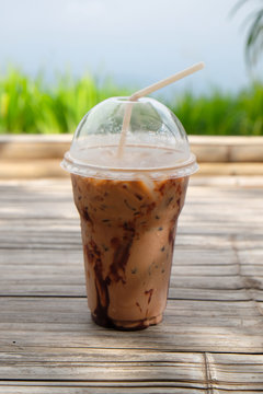 Iced coco or chocolate with straw in plastic cup