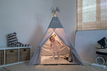 Girl playing in the teepee © familylifestyle