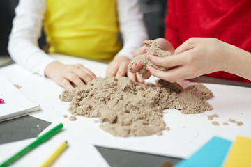 Kids playing with kinetic sand in elementary school