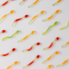 Colorful pattern made of gummy candies on bright background. Minimal food concept. Flat lay.