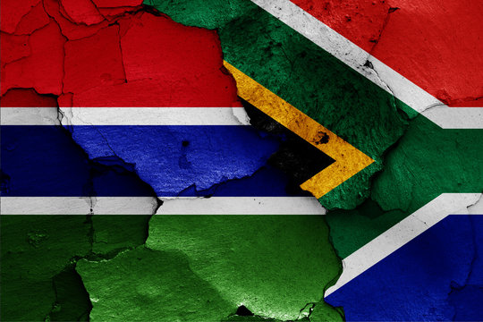 flags of Gambia and South Africa painted on cracked wall